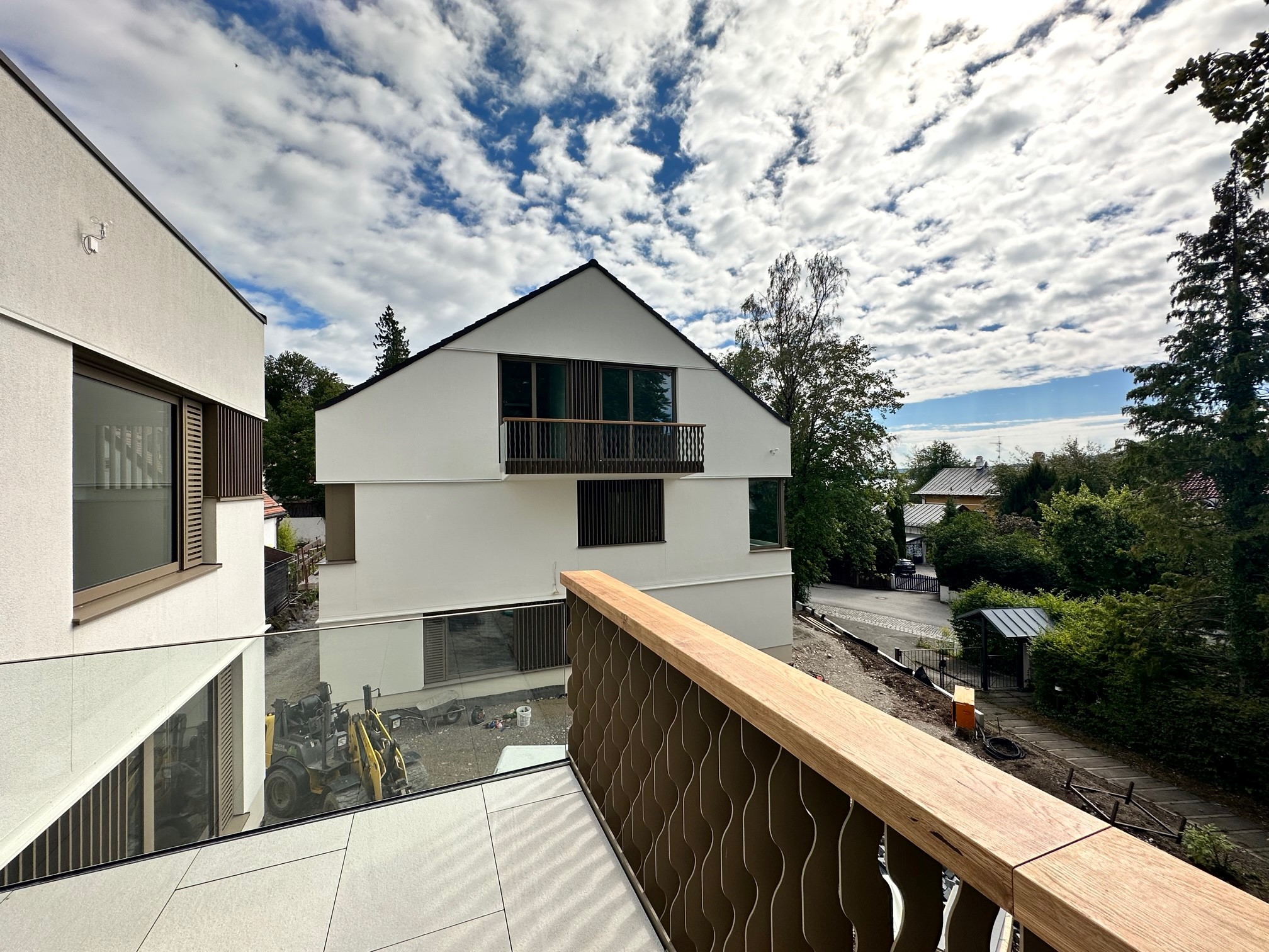 Balcony, glass balustrade, rendered façade